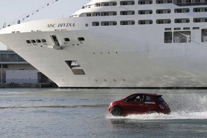 red fiat in the water escorting msc cruise ship
