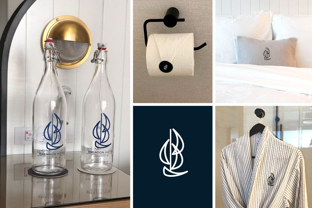 brenton hotel branded items, glass water bottles, toilet paper, embroidered pillow and bathrobe