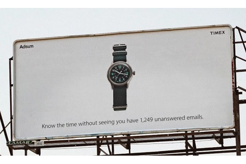 One of six cool examples in marketing, this Timex billboard shows a picture of a watch and the caption "check the time without seeing you have 1,269 unanswered emails."