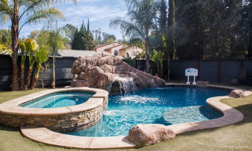 An aqua blue swimming pool with a stone waterfall feature is just one of the six surprising things you can rent by the hour.