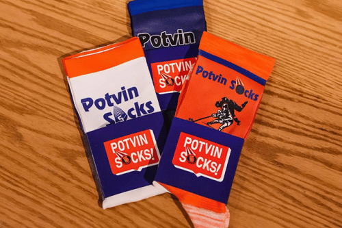 Three pairs of Denis "Potvin Socks" in orange, blue, and white, which are excellent examples of how to promote your brand's weaknesses strategically.